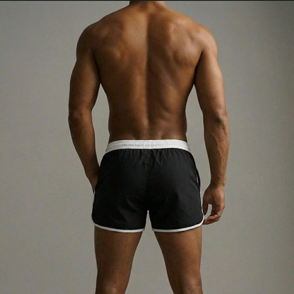 Elite Club Herren Badehose schwarz Rückansicht mit weißem Bund, sportlicher Slim Fit, minimalistisch, Studiohintergrund